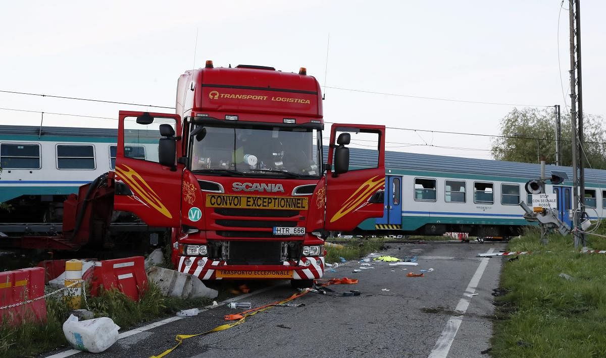 The wreckage of a truck sits next to a railroad crossing where it was hit my a regional train in Caluso, outside Turin, Italy, early Thursday, May 24, 2018. At least two were killed and over a dozen injured in the crash. AP/PTI
