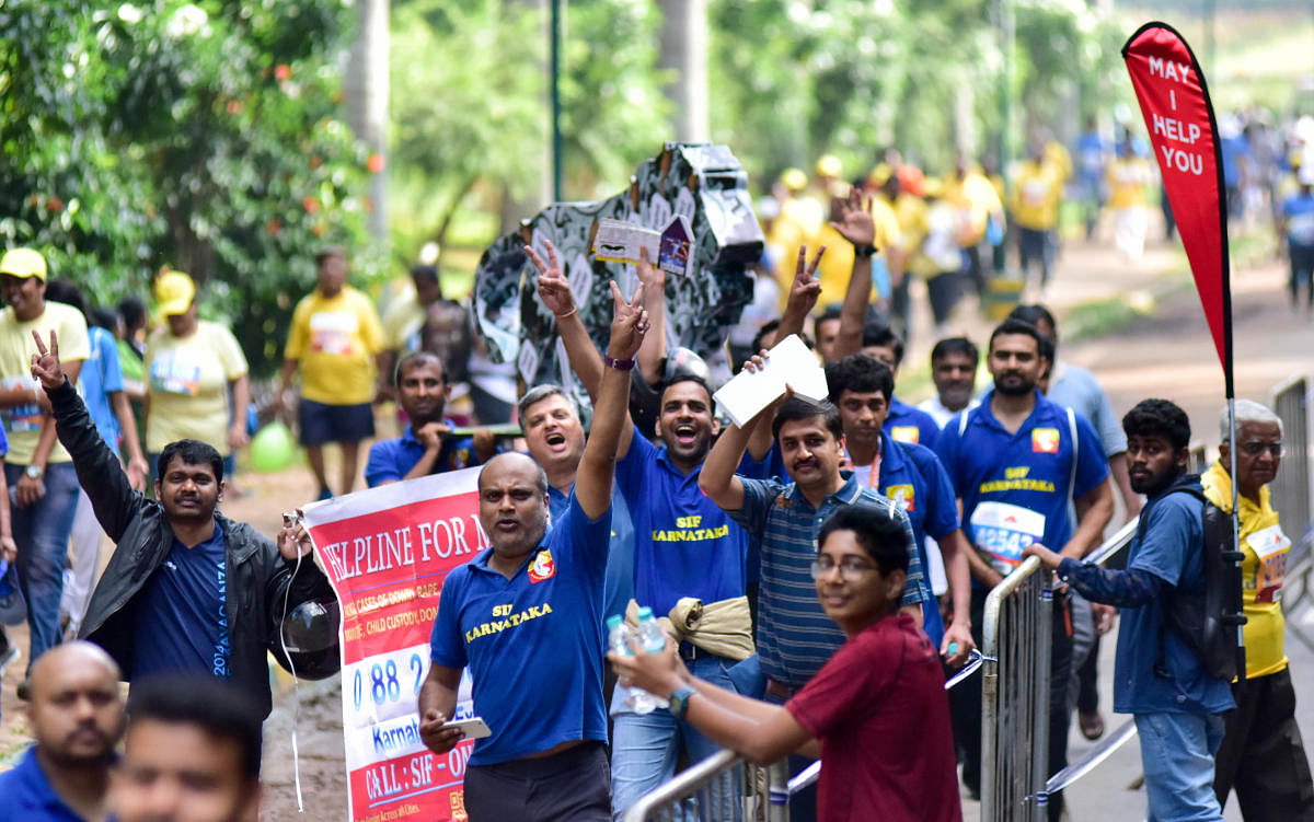 People participate with social slogans in TCS world 10 K run, at Sree Kanteerava Stadium, in Bengaluru on Sunday.DH Photo