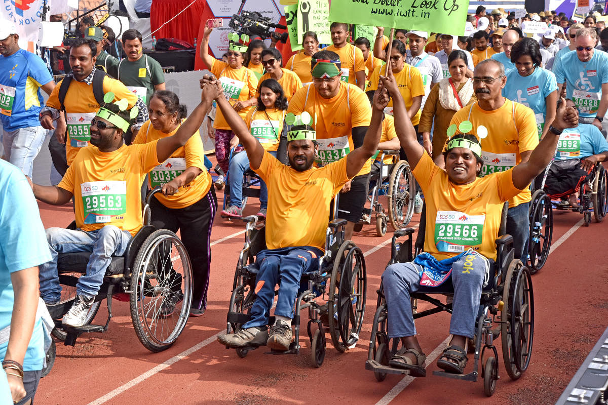 Physically challenged people participate in TCS world 10K run organised by Procam International Private Limited at Kanteerava Stadium in Bengaluru on Sunday.DH Photo