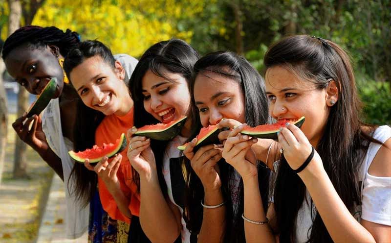 Young women pose while eating watermelons, on a hot summer day, in Amritsar, on Monday, May 28, 2018. ( PTI Photo)