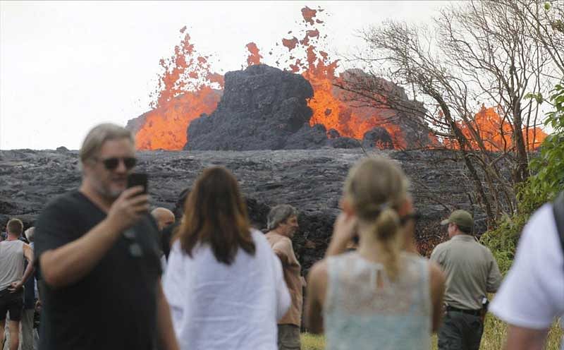Pahoa: In a Saturday, May 26, 2018 photo, area residents, the media and national guard flock to what is now the end of Leilani Avenue to take in the fiery show at fissures 2, 7 and 8 of the Kilauea volcano near Pahoa. AP/PTI