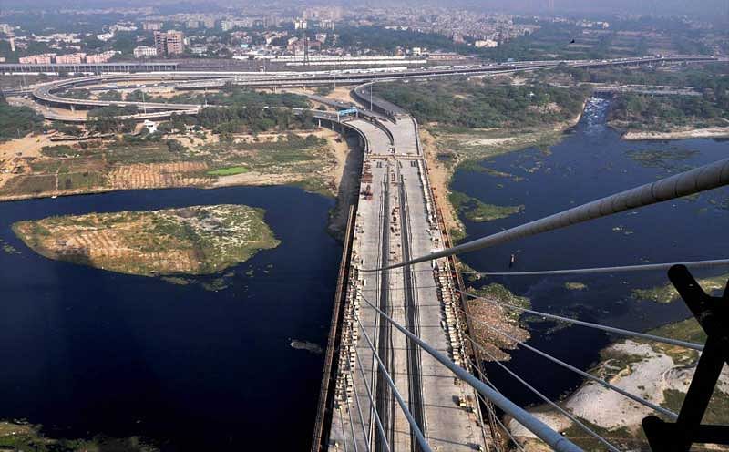 An aerial view of the Delhi's iconic Signature Bridge, in New Delhi, on Tuesday, May 29, 2018. Construction of the much-delayed bridge which was announced in 2004, the project was initially expected to be completed before the 2010 Commonwealth Games. The bridge had obtained environmental clearance in 2011 and was set to be completed by December 2013. The date of completing the project was pushed to June 2016 and then to July 2017, which was further pushed to December 2017 and now expected to complete in 2018. (PTI Photo)