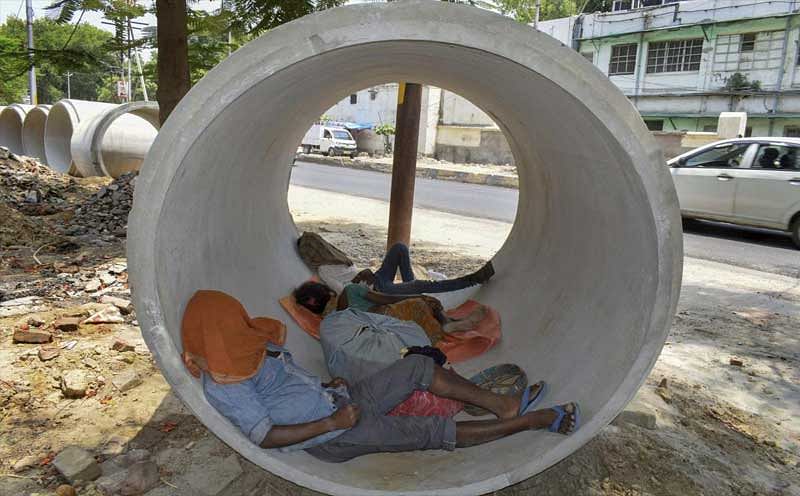 Allahabad: People sleep inside a concrete-pipe on a hot summer day, in Allahabad on Tuesday. (PTI Photo)