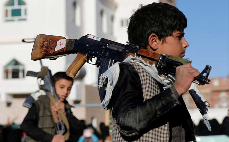 Boys carry rifles as they attend a gathering held by women loyal to the Houthi movement to show their support in Sanaa, Yemen January 14, 2018. REUTERS