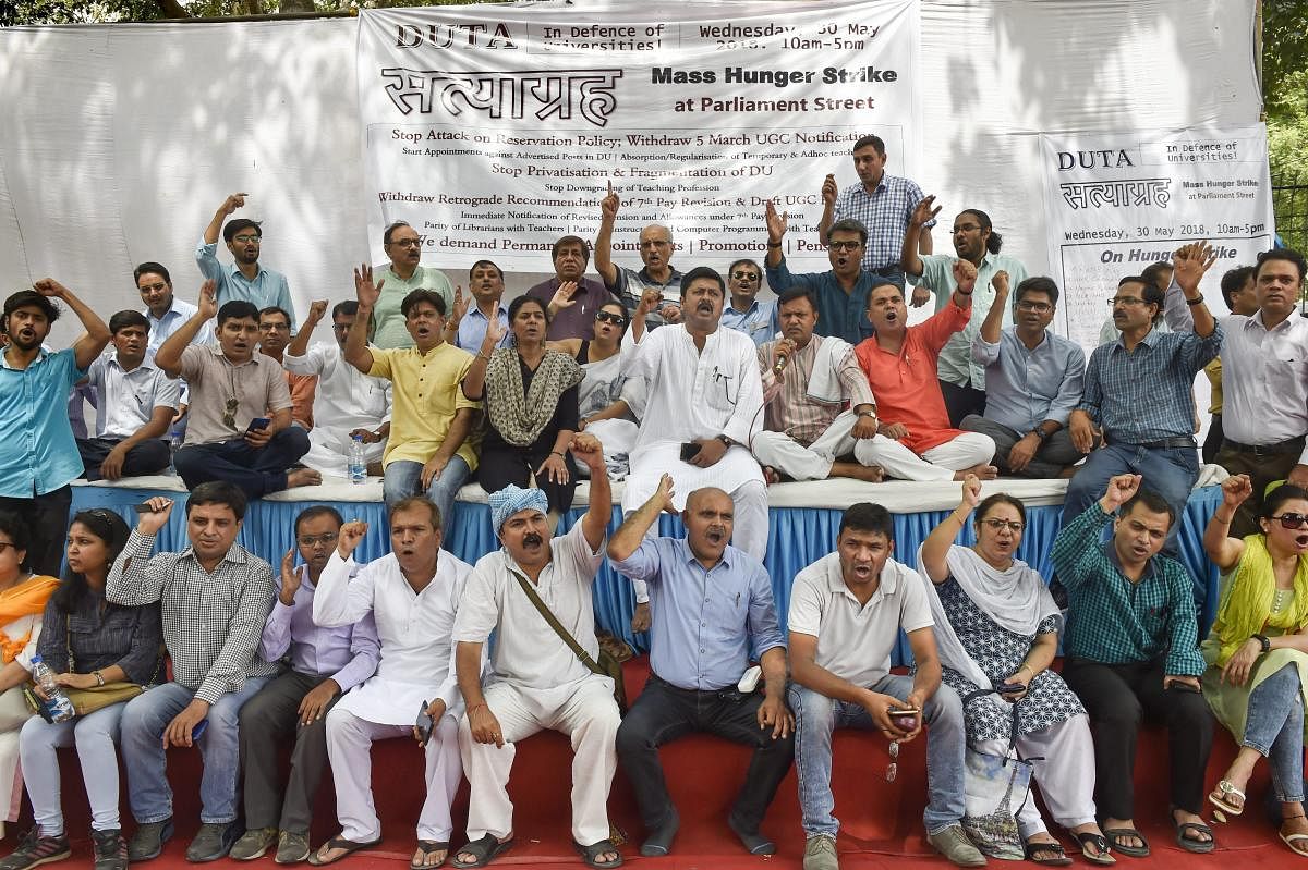 New Delhi: Delhi University Teachers' Association (DUTA) members hald a protest for their various demands, in New Delhi on Wednesday, May 30, 2018. (PTI Photo)