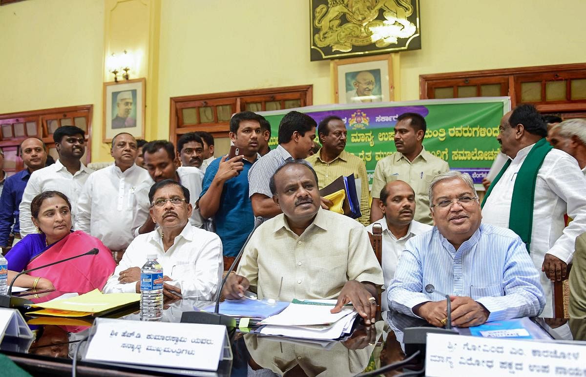 Bengaluru: Karnataka Chief Minister H D Kumaraswamy, his deputy G Parameshwara and Chief Secretary Ratnaprabha (L) during a meeting with the farmers on the issue of loan waiver, in Bengaluru on Wednesday, May 30, 2018. (PTI Photo)