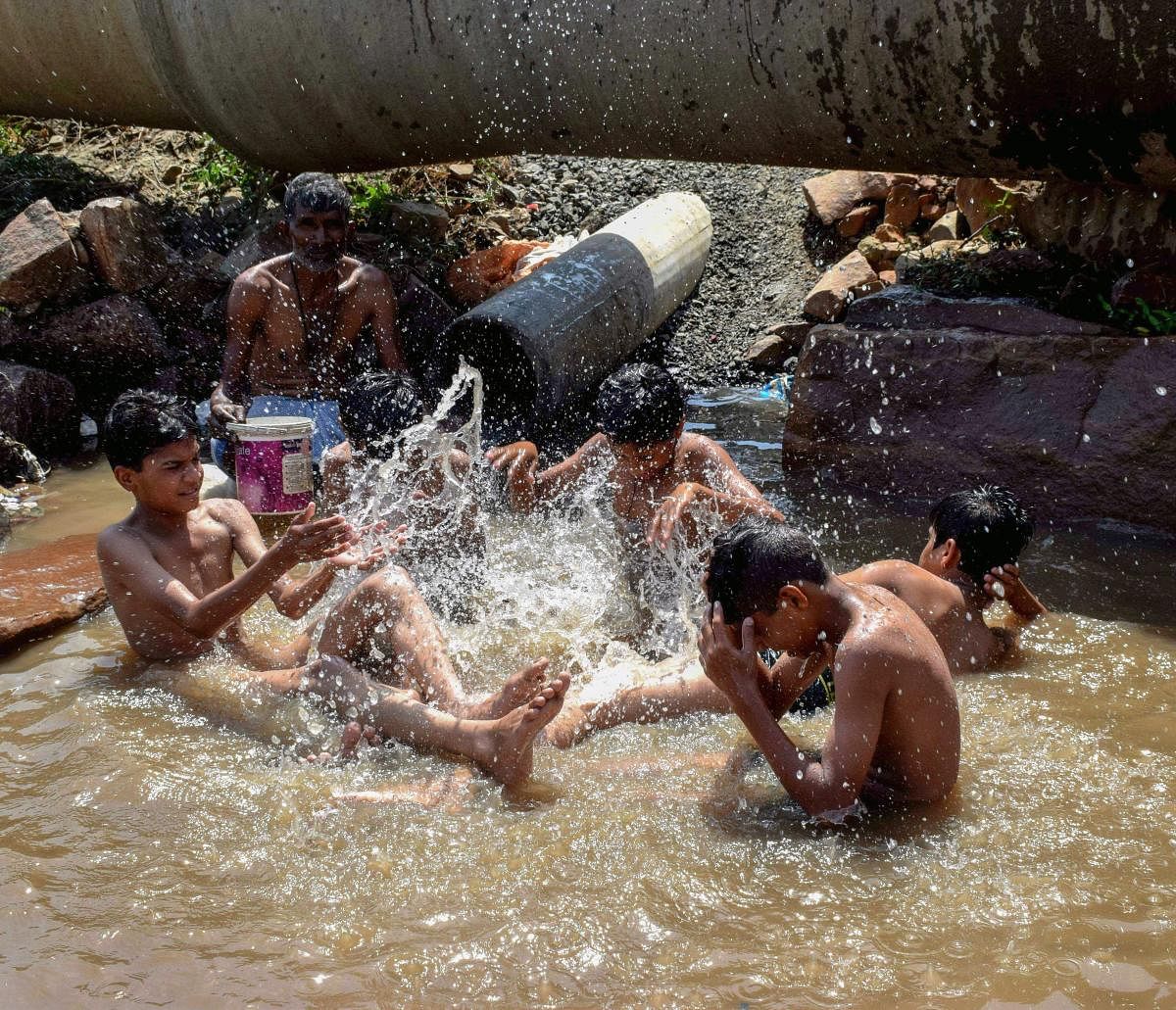 Bhopal: Children play in a pond on a hot summer afternoon, in Bhopal on Wednesday, May 30, 2018. (PTI Photo)