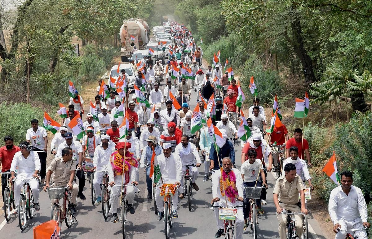 Sirsa: Congress leaders and party workers take part in 'Haryana Bachao Parivartan Lao' cycle yatra, in Sirsa, Haryana on Thursday, May 31, 2018. (PTI Photo)