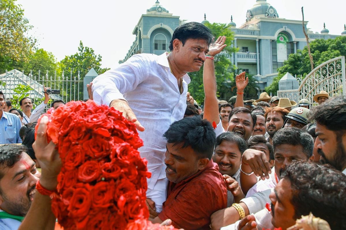 Bengaluru: Congress Party candidate Munirathna Naidu celebrates after winning from Rajarajeshwari Nagar constituency for Karnataka Assembly poll which was postponed to May 27, due to election-related malpractices, in Bengaluru on Thursday, May 31, 2018. (PTI Photo)