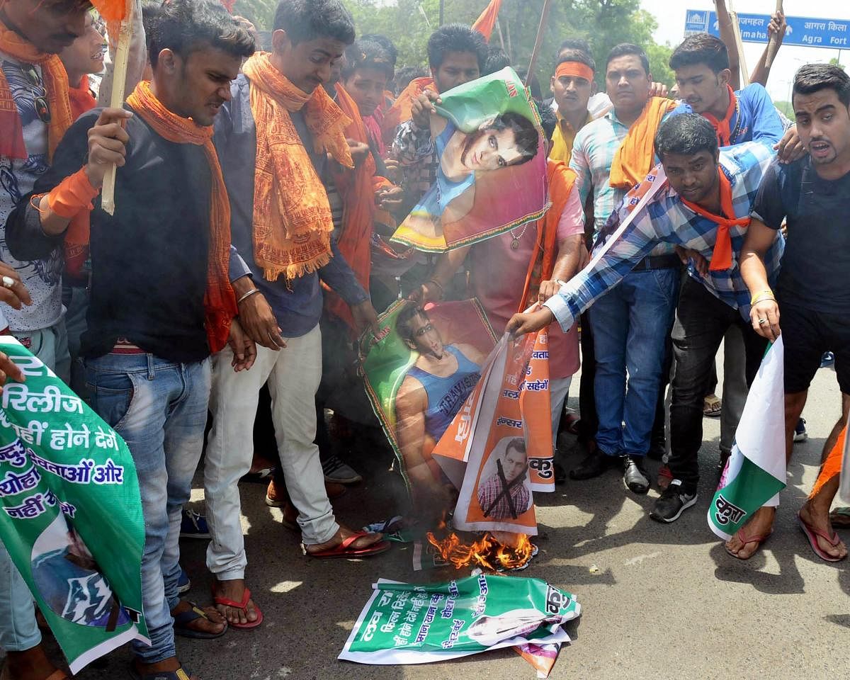 Agra: Members of Hindu Vahini Sangathan burn posters of actor Salman Khan during a protest against his upcoming movie 'Loveratri', in Agra on Thursday, May 31, 2018. (PTI Photo)
