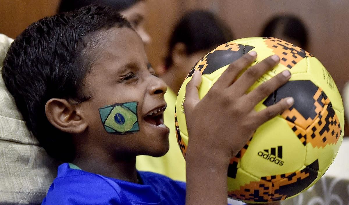 A visually impaired child plays with a football during the celebration of FIFA World Cup 2018, in Kolkata. PTI Photo