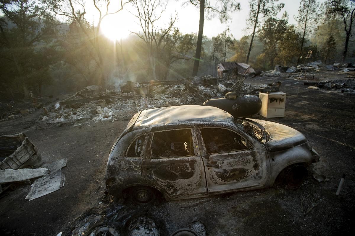 A vehicle scorched by a wildfire rests in a clearing on Wolf Creek Road near Clearlake Oaks, Calif., Sunday, June 24, 2018. Wind-driven wildfires destroyed buildings and threatened hundreds of others Sunday as they raced across dry brush in rural Northern California. AP/PTI
