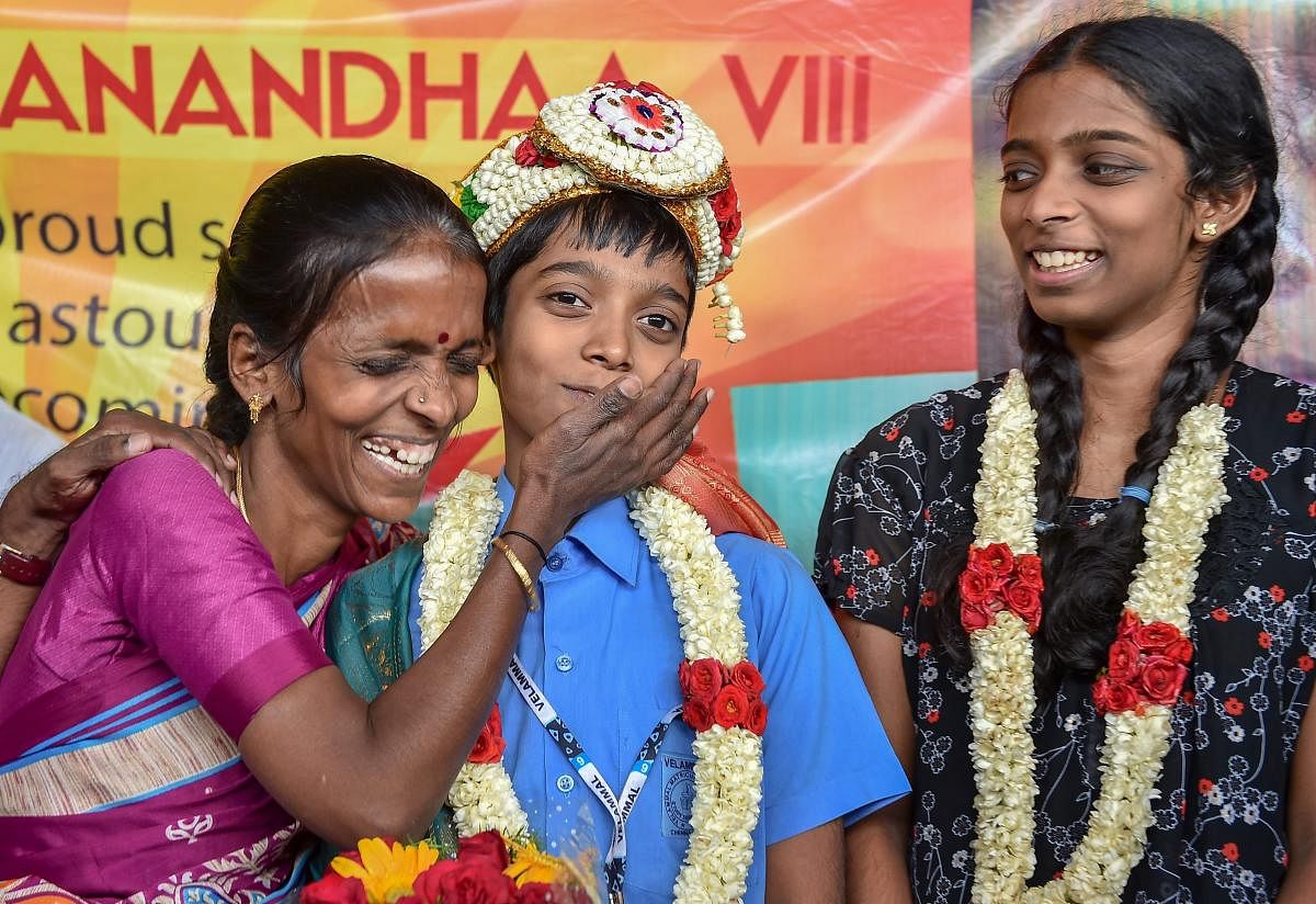 Indian Chess Grandmaster Rameshbabu Praggnanandhaa being greeted by his mother Nagalakshmi as his sister looks on, on his arrival, at Chennai Airport on Tuesday, June 26, 2018. Praggnanandhaa has become the country’s youngest, and the world’s second youngest, Chess Grandmaster at the age of 12 years. PTI