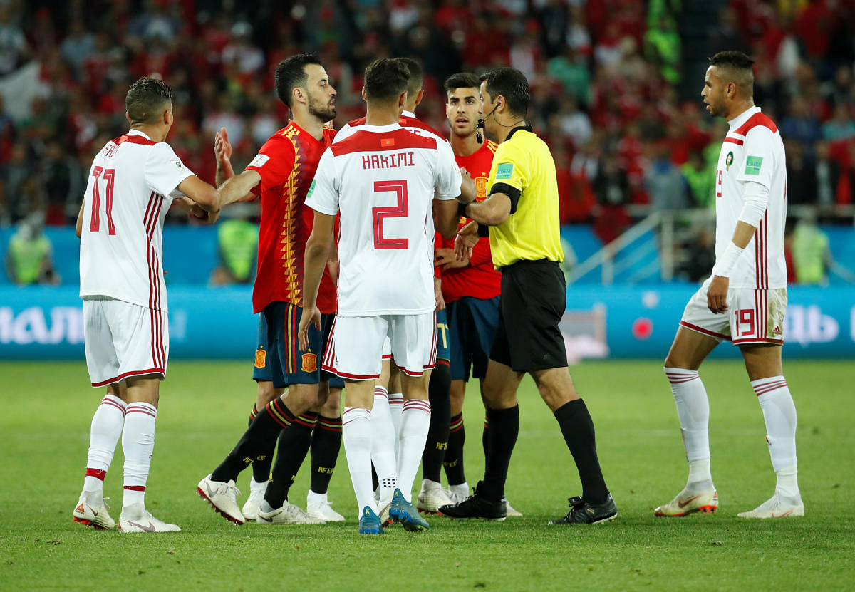World Cup - Group B - Spain vs Morocco - Kaliningrad Stadium, Kaliningrad, Russia - June 25, 2018 Referee Ravshan Irmatov separates players at the end of the match. Reuters