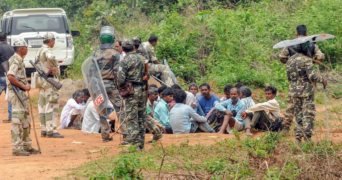 Security personnel detain villagers while carrying out a search operation at the remote village Ghagra, where Member of Parliament (MP) Karia Munda's three bodyguards, belonging to Jharkhand Police, were allegedly kidnapped by Pathalgarhi supporters, in Khunti district on Wednesday, June 27, 2018. PTI