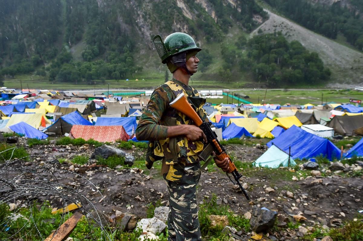 CRPF personnel stands guard near Amarnath base camp at Baltal, in Ganderbal district of central Kashmir on Thursday, June 28, 2018. The annual two-month Amarnath Yatra to commence on Thursday was halted dur to bad weather and heavy rainfall. PTI