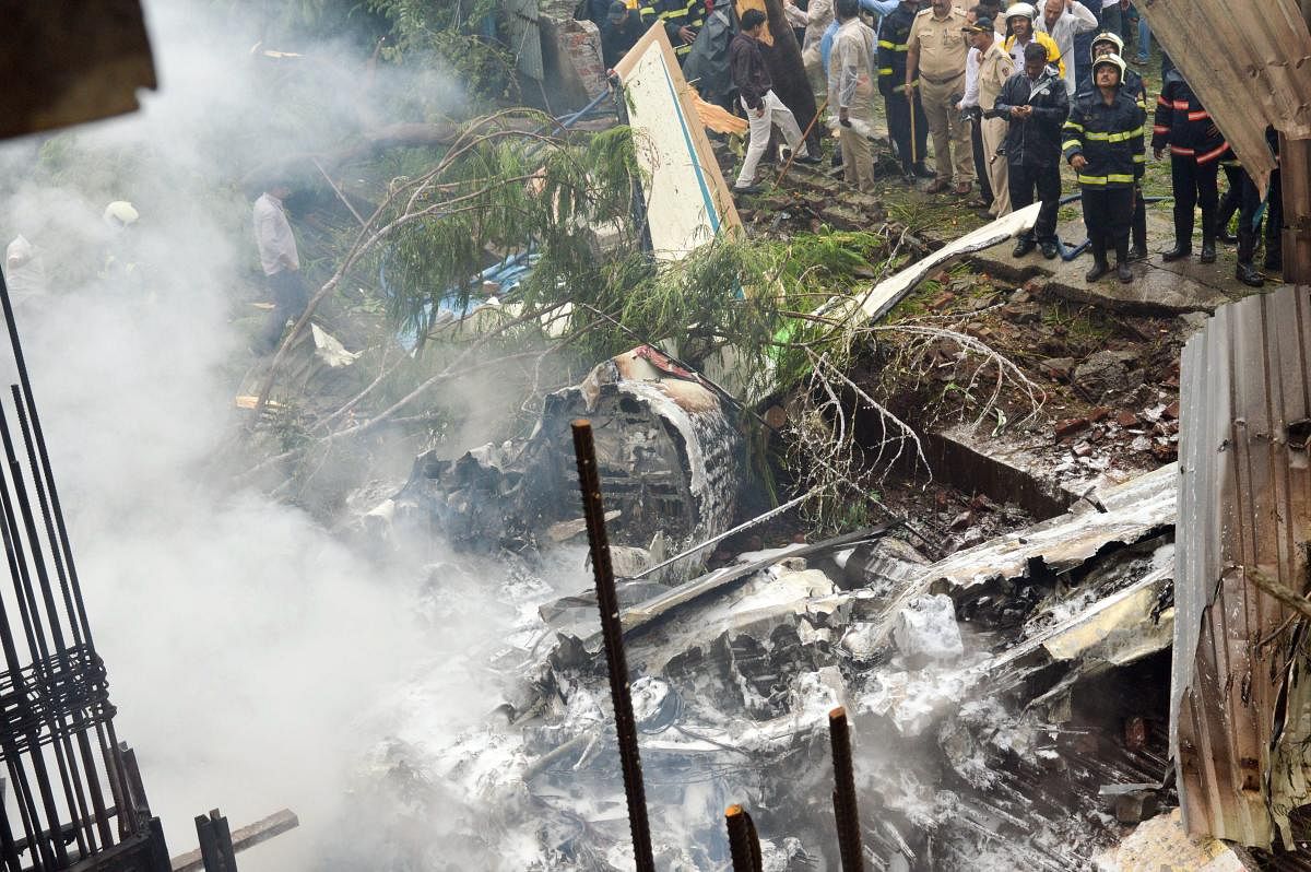 Firemen stand-by as they try to douse the smouldering remains of the chartered plane that crashed in Ghatkopar's Jivdaya Lane, killing 5, in Mumbai on Thursday, June 28, 2018. PTI