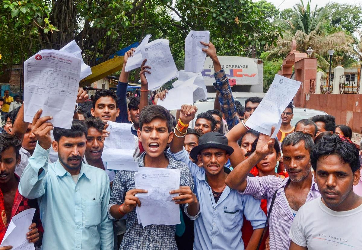 Students display their mark sheets during a protest against poor pass percentage in Matriculation exams, outside Bihar School Examination Board office in Patna on Friday, June 29, 2018. (PTI Photo)