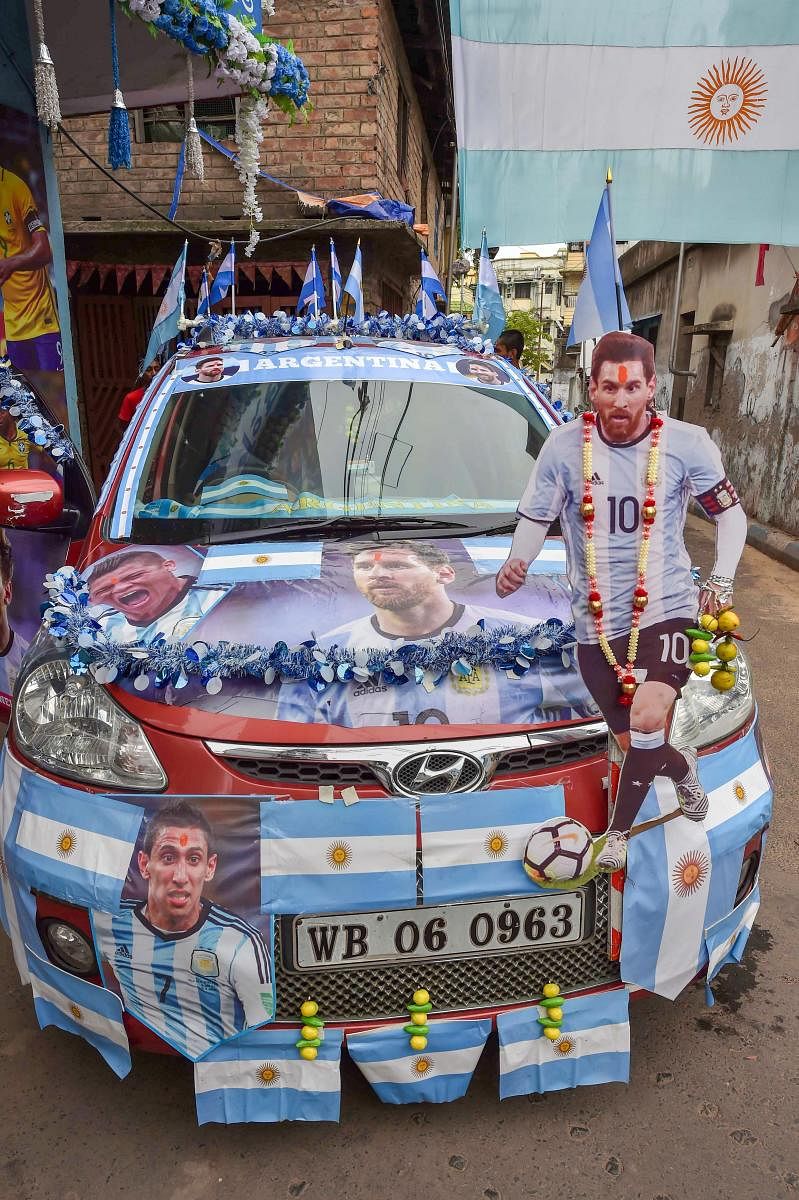 Argentina fans cheer with the posters of the country's football team players, ahead of Argentina vs France match at FIFA World cup 2018, in Kolkata on Saturday, June 30, 2018. (PTI Photo)