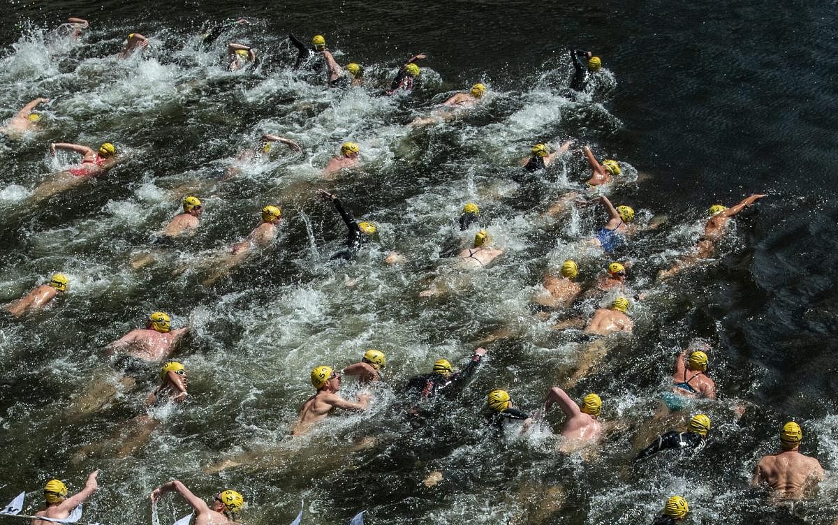 People take part in the 'Berliner Flussbad-Pokal' river swimming contest along the river Spree, all the way from the Bode Museum to the Schlossbruecke in Berlin, Germany, 01 July 2018. Photo: Paul Zinken/dpa.DPA/PTI