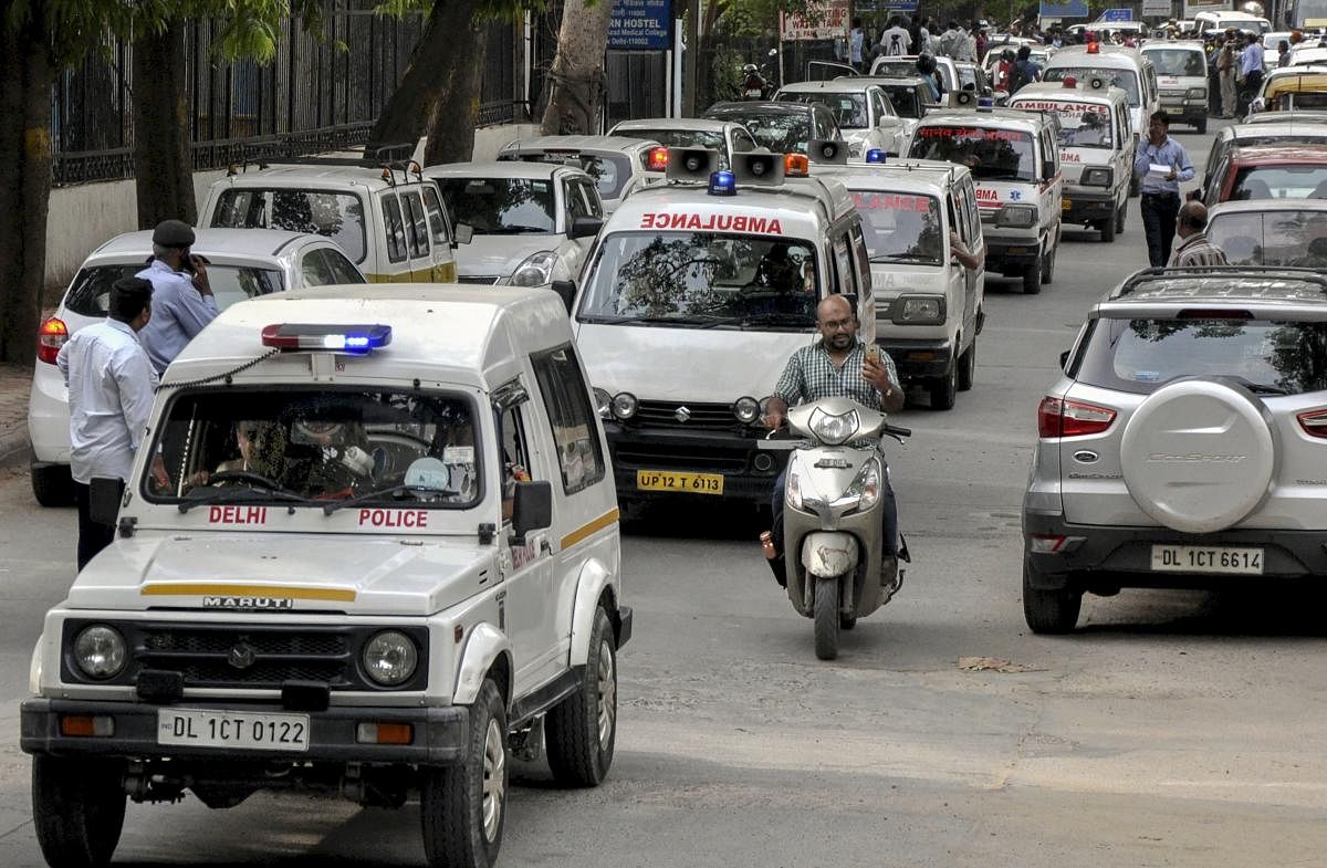 Police vehicles escort the ambulances carrying the bodies of 11 family members, who were found hanging at their residence in Burari area, to Nigambodh Ghat for cremation, in New Delhi on Monday, July 02, 2018. (PTI Photo)