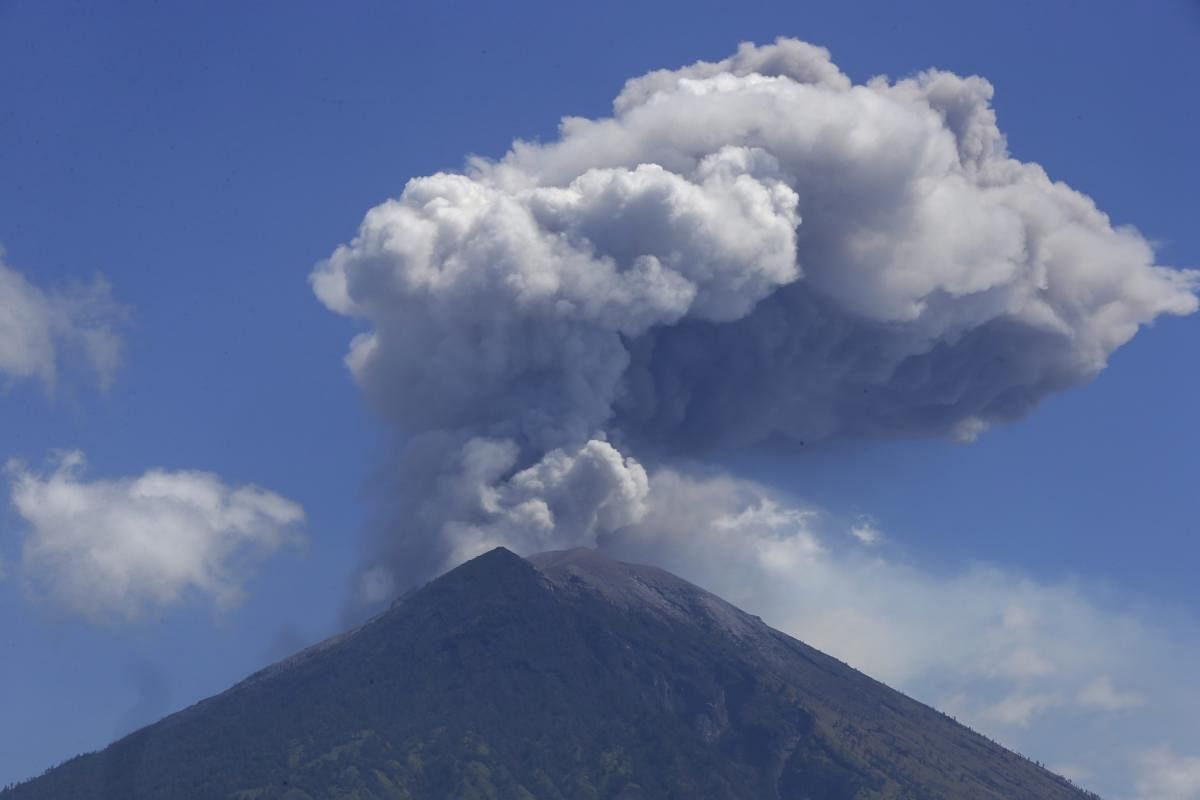Mount Agung volcano spews ash and smoke in Karangasem, Bali, Indonesia, Wednesday, July 4, 2018. The volcano on the Indonesian tourist island of Bali erupted Monday evening, ejecting a 2,000-meter-high (6,560-foot-high) column of thick ash and hurling lava down its slopes. AP/PTI
