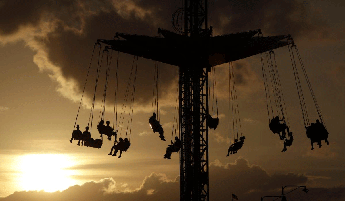 The sun begins to set behind fairgoers hanging from the Sky Flyer ride at the State Fair Meadowlands carnival, Thursday, July 5, 2018, in East Rutherford, N.J. AP/PTI