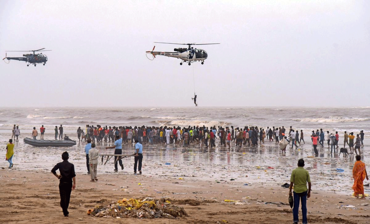 A Navy and a Coast Guard Chetak helicopter fly over the Juhu beach during a search operation to find four persons, who are feared to have been drowned on Thursday night, at Juhu Chowpatty in Mumbai on Friday, July 05, 2018. (PTI Photo)