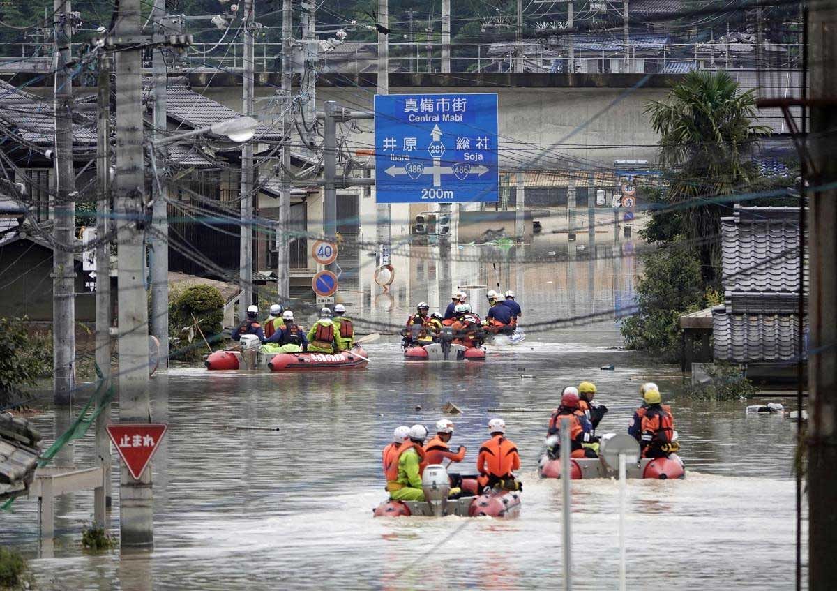 Rescuers on boats head for search in the flooded Kurashiki city, after heavy rains, Okayama prefecture, southwestern Japan, Sunday, July 8, 2018. Heavy rainfall hammered southern Japan for the third day, prompting new disaster warnings on Kyushu and Shikoku islands Sunday. AP/PTI