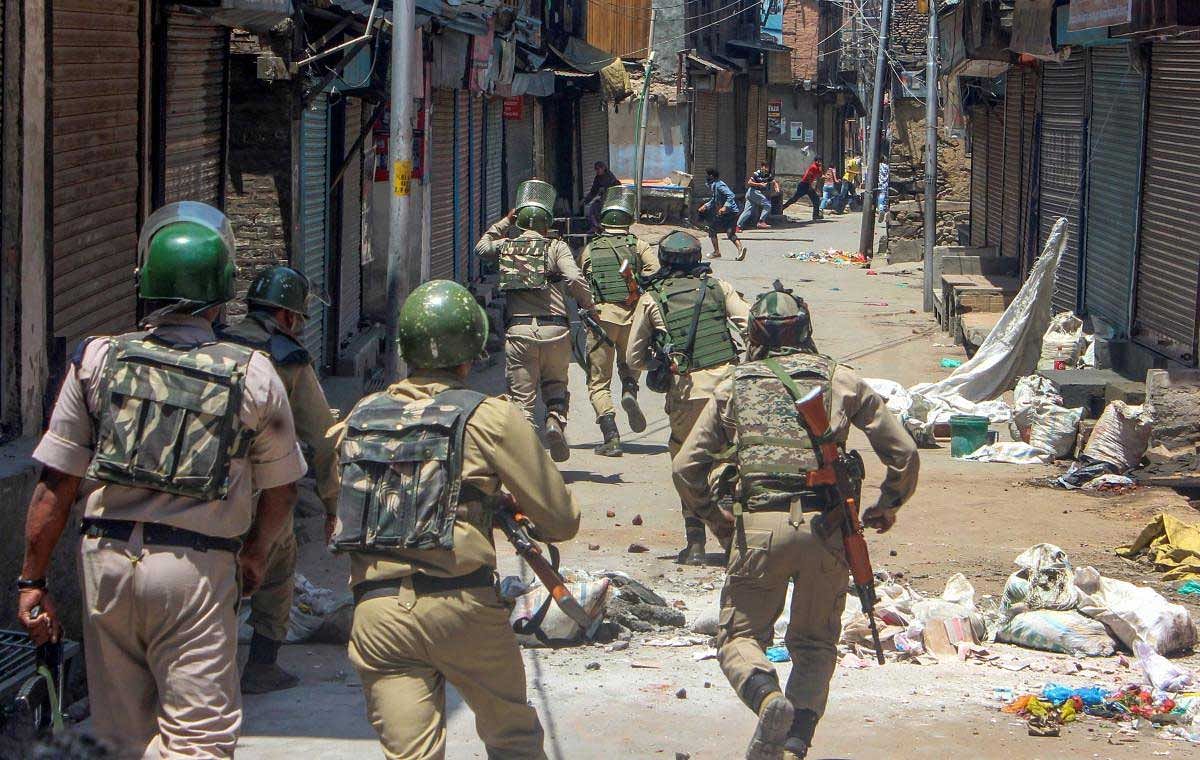 CRPF personnel in action against people protesting the killing of three civilians in firing by security forces at Kulgam yesterday, in Srinagar, on Sunday, July 8, 2018. (PTI Photo)