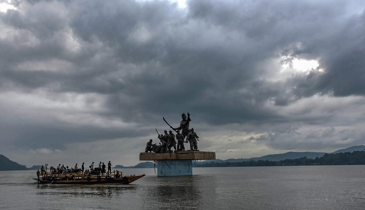 A passenger boat ferries across people while dark clouds hover over river Brahmaputra, in Guwahati on Monday, July 09, 2018. (PTI Photo)