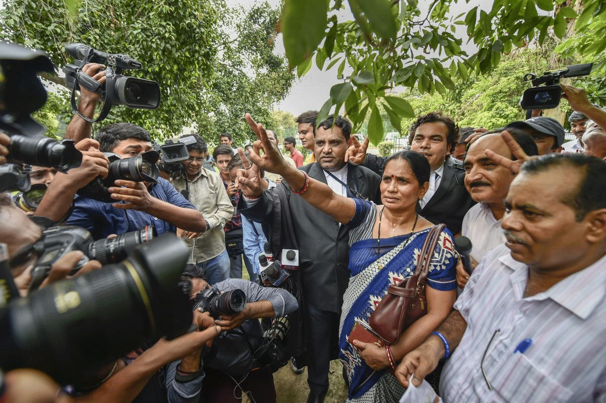 Nirbhaya's mother Asha Devi shows victory sign after the Supreme Court's verdict on Dec 2012 gang rape case, in New Delhi on Monday, July 9, 2018. The apex court upheld the death sentence of the three convicts in the case. PTI Photo