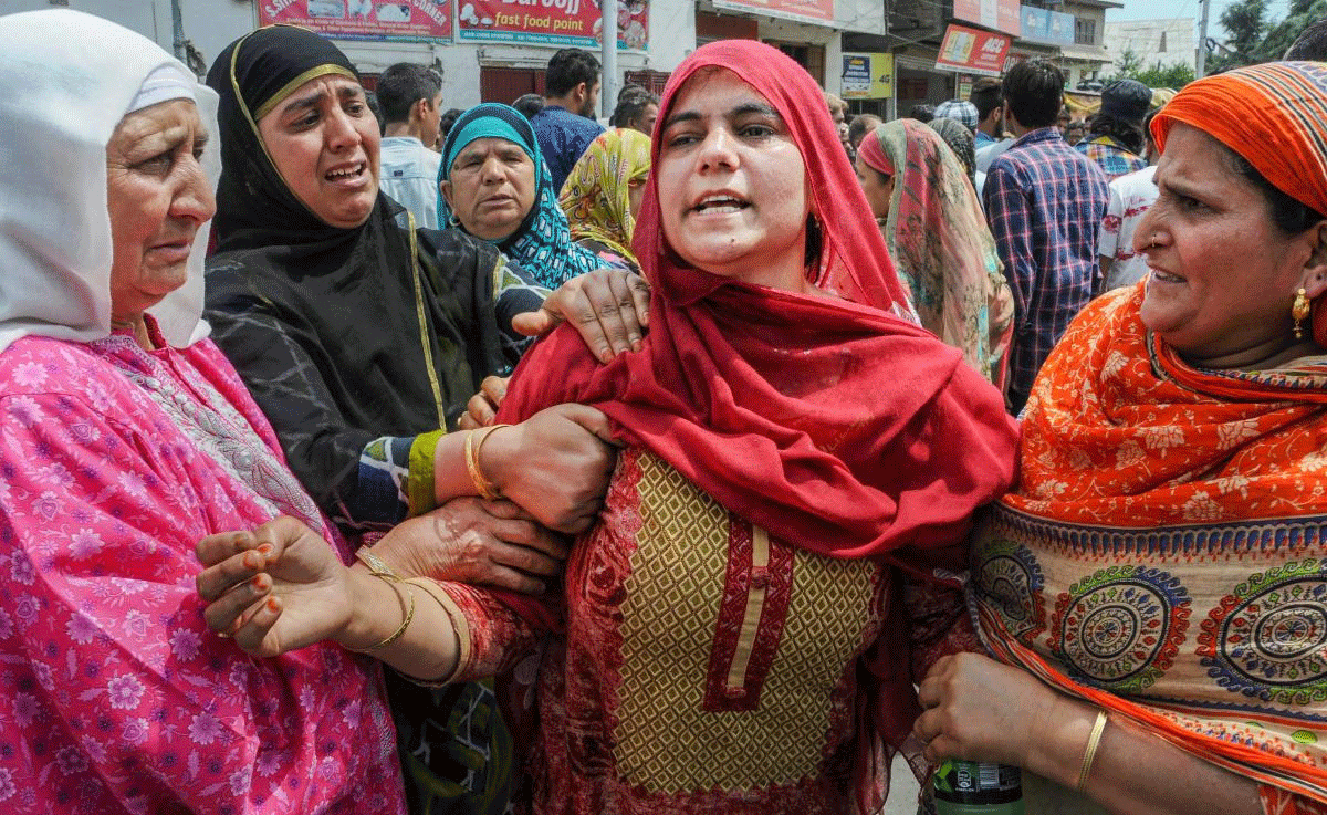Women wail while blocking the Airport Road during a protest over the arrest of four youths in connection with the Hyderpora grenade attack, in Srinagar on Monday, July 9, 2018. (PTI Photo)