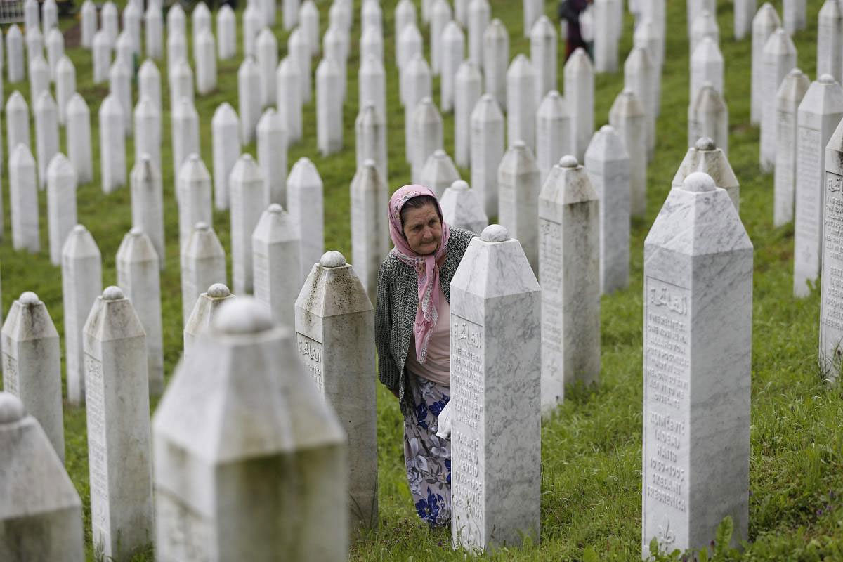 A Bosnian Muslim woman walks among gravest at the memorial centre of Potocari near Srebrenica, 150 kms north east of Sarajevo, Bosnia, Wednesday, July 11, 2018. Thousands of Bosnian Muslims have gathered in Srebrenica on the 23rd anniversary of Europe's worst massacre since World War II to hold prayers and attend the funeral for 35 recently identified victims. AP/PTI
