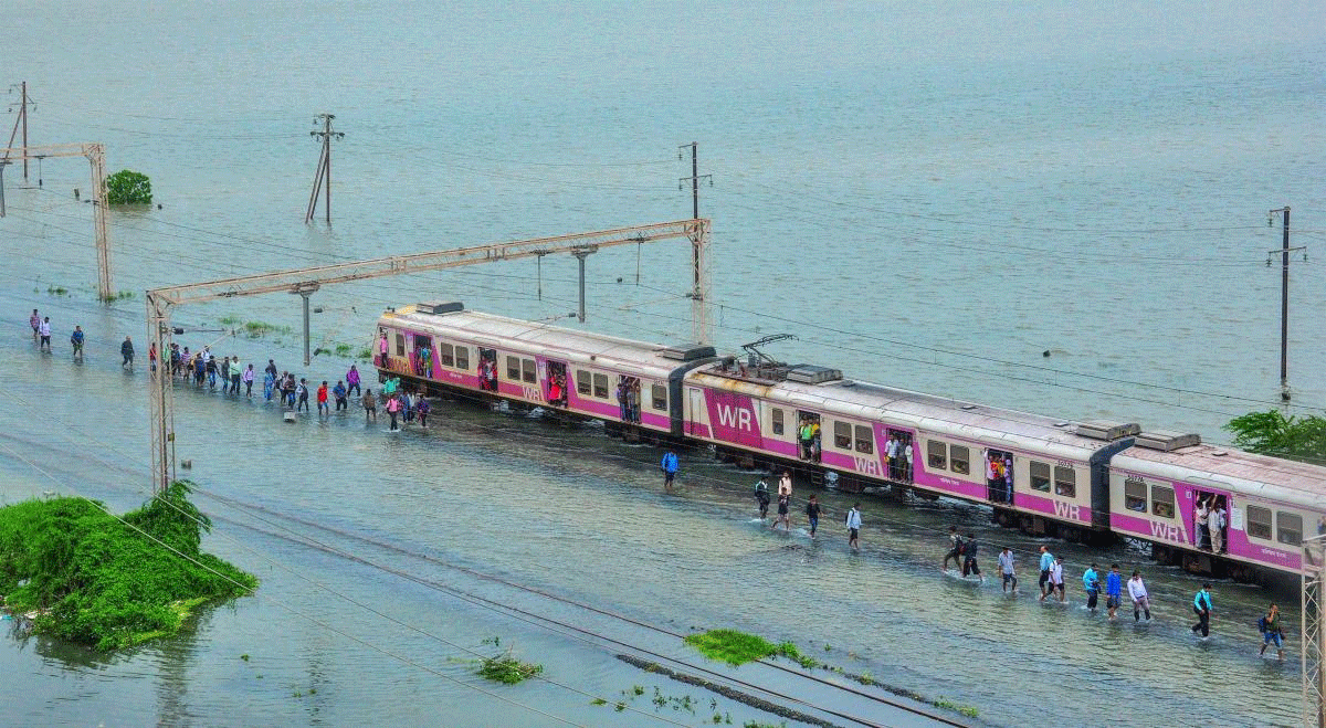 Commuters stranded on their way to Mumbai as a section of Western Raillway remained suspended due to waterlogging on tracks, after heavy rainfall at Nallasopara area, in Mumbai on Tuesday, July 11, 2018. (PTI Photo)