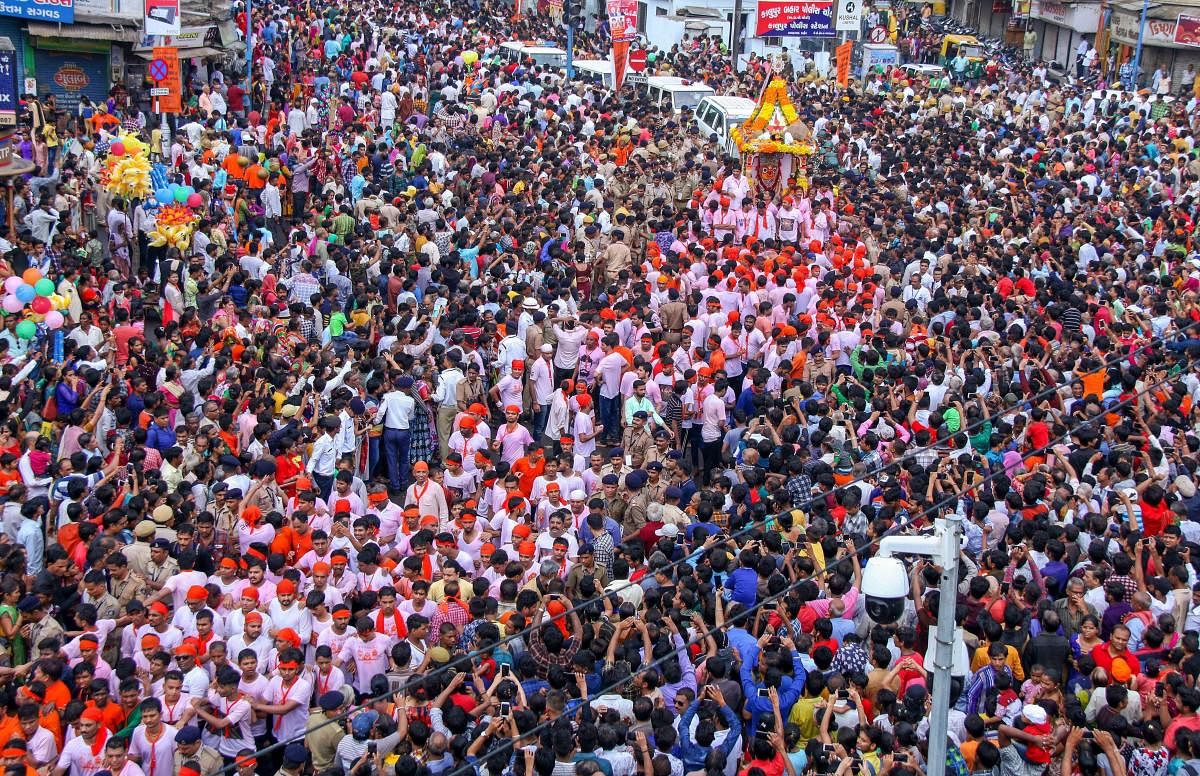 Devotees pull the chariot of Lord Jagannath during the 141st Rath Yatra, in Ahmedabad on Saturday, July 14, 2018. The yatra is taken out every year on Ashadhi Bij, the second day of Ashad month, as per the Hindu calender. Besides the three chariots of Lord Jagannath, his brother Balram and sister Subhadra, the yatra procession comprises of 18 decorated elephants, 101 trucks with tableaux, members of 30 religious groups and 18 singing troupes. (PTI Photo)