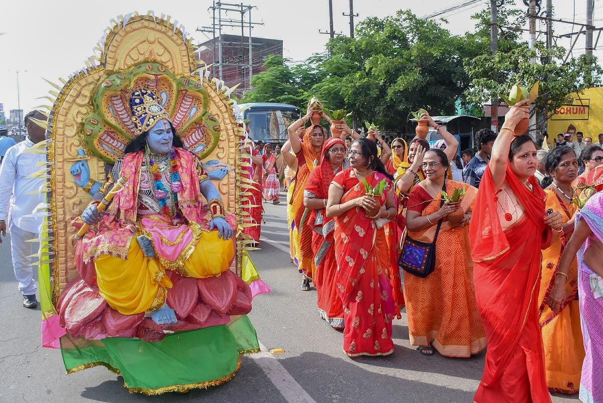 Devotees during the 141st Rath Yatra, in Guwahati on Saturday, July 14, 2018. The yatra is taken out every year on Ashadhi Bij, the second day of Ashad month, as per the Hindu calender. Besides the three chariots of Lord Jagannath, his brother Balram and sister Subhadra, the yatra procession comprises of 18 decorated elephants, 101 trucks with tableaux, members of 30 religious groups and 18 singing troupes. (PTI Photo)