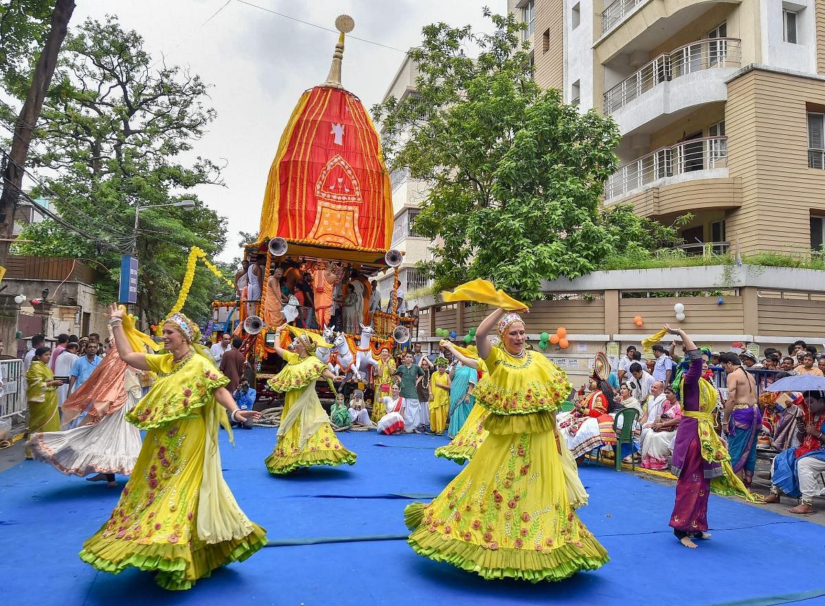 Russian devotees perform as others pull the rope of a chariot of Lord Jagannath during 141st Rath yatra, at ISKCON temple in Kolkata on Saturday, July 14, 2018. (PTI Photo/Swapan Mahapatra)