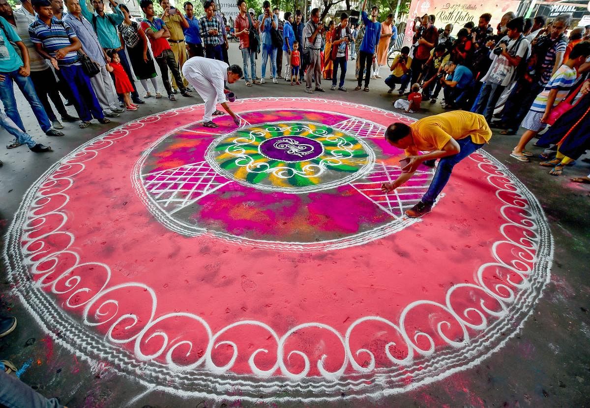 Devotees prepare Rangoli on a city street during 141st Rath yatra, at ISKCON temple in Kolkata on Saturday, July 14, 2018. (PTI Photo/Swapan Mahapatra)