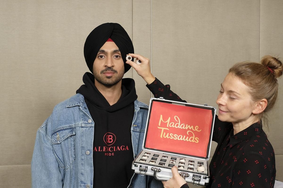 Actor and singer Diljit Dosanjh gives measurements for a wax statue to be displayed at Madame Tussauds Delhi, in Mumbai on Saturday, July 14, 2018. (Handout Photo via PTI)