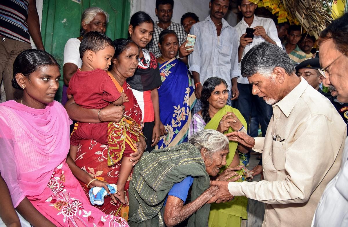 Andhra Pradesh Chief Minister N Chandrababu Naidu meets an elderly woman during Grama Darshini village walk and Grama Sabha at Donepudi village, in Guntur on Monday, July 16, 2018. (PTI Photo)
