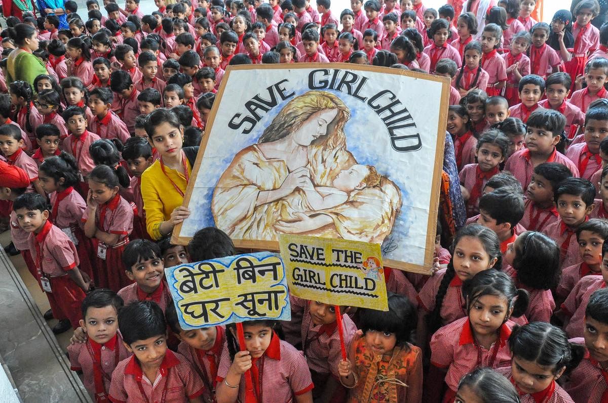 Children hold a placard displaying a message to 'Save Girl Child', in Moradabad on Tuesday, July 17, 2018. (PTI Photo)