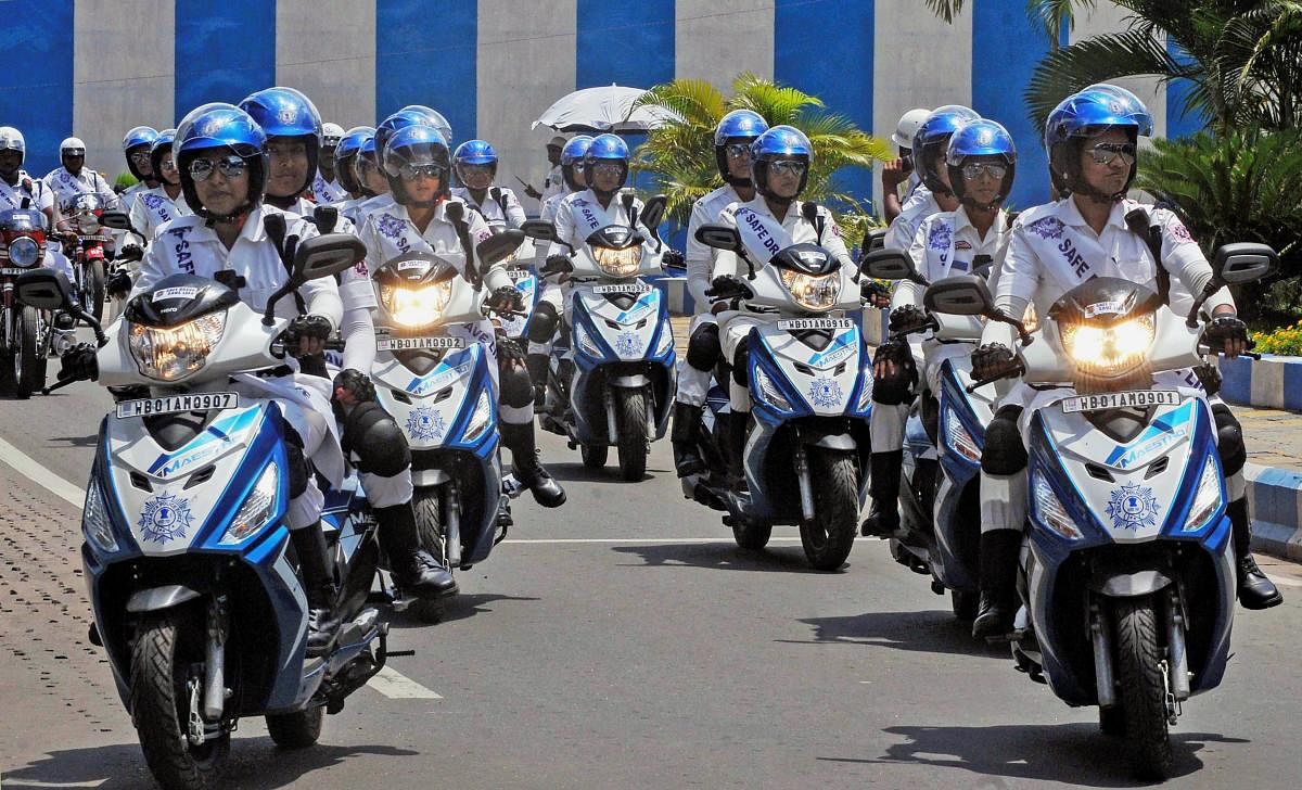 The new women wing (female traffic police on scooters) of Kolkata Police ‘The Winners’ present a display during the flagging-off of various speed bus services connecting Kolkata, the state headquarters, with all district headquarters, in Kolkata on Wednesday. (PTI Photo)