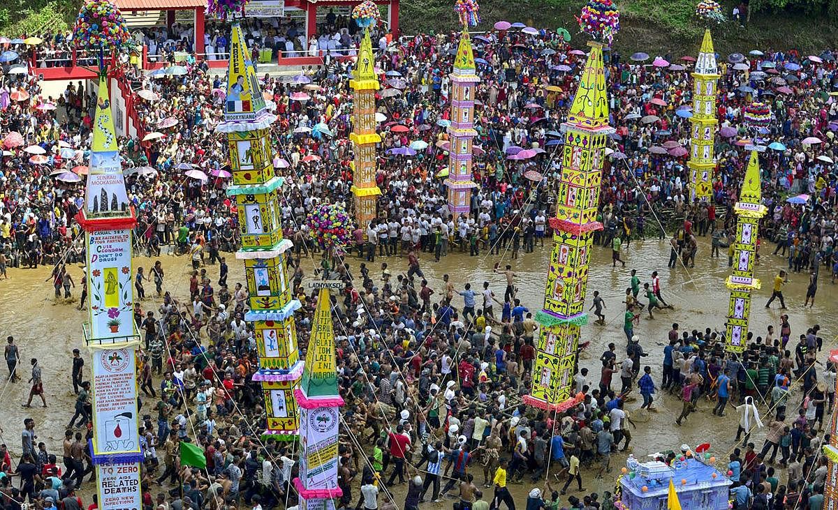 Jaintia tribesmen carry a traditional ‘rongs’ or chariots as they celebrate the ancient Behdeinkhlam festival, at Tuber village in Jaintia Hills on Thursday. (PTI Photo)