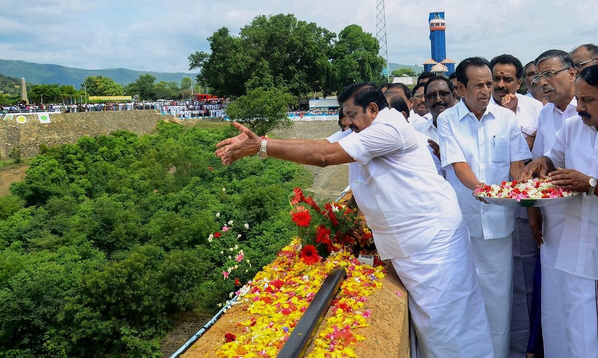 Tamil Nadu Chief Minister Edappadi K Palaniswami opens the sluice gate of Mettur dam to release disputed-river Cauvery water, in Salem on Thursday. (PTI Photo)