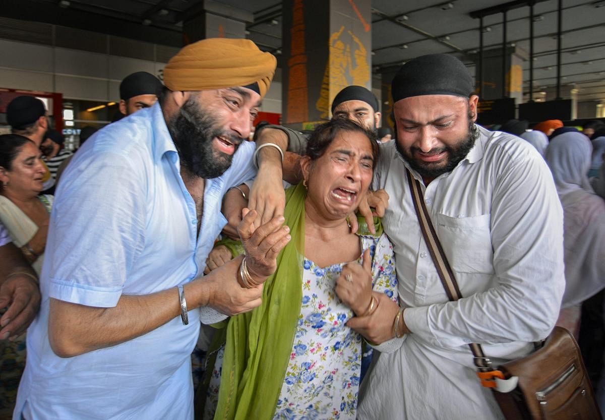 Inconsolable relatives of the victims of the recent suicide bombings on Sikhs and Hindus in Jalalabad (Afghanistan), on their arrival at the IGI Airport in New Delhi on Thursday. (PTI Photo)