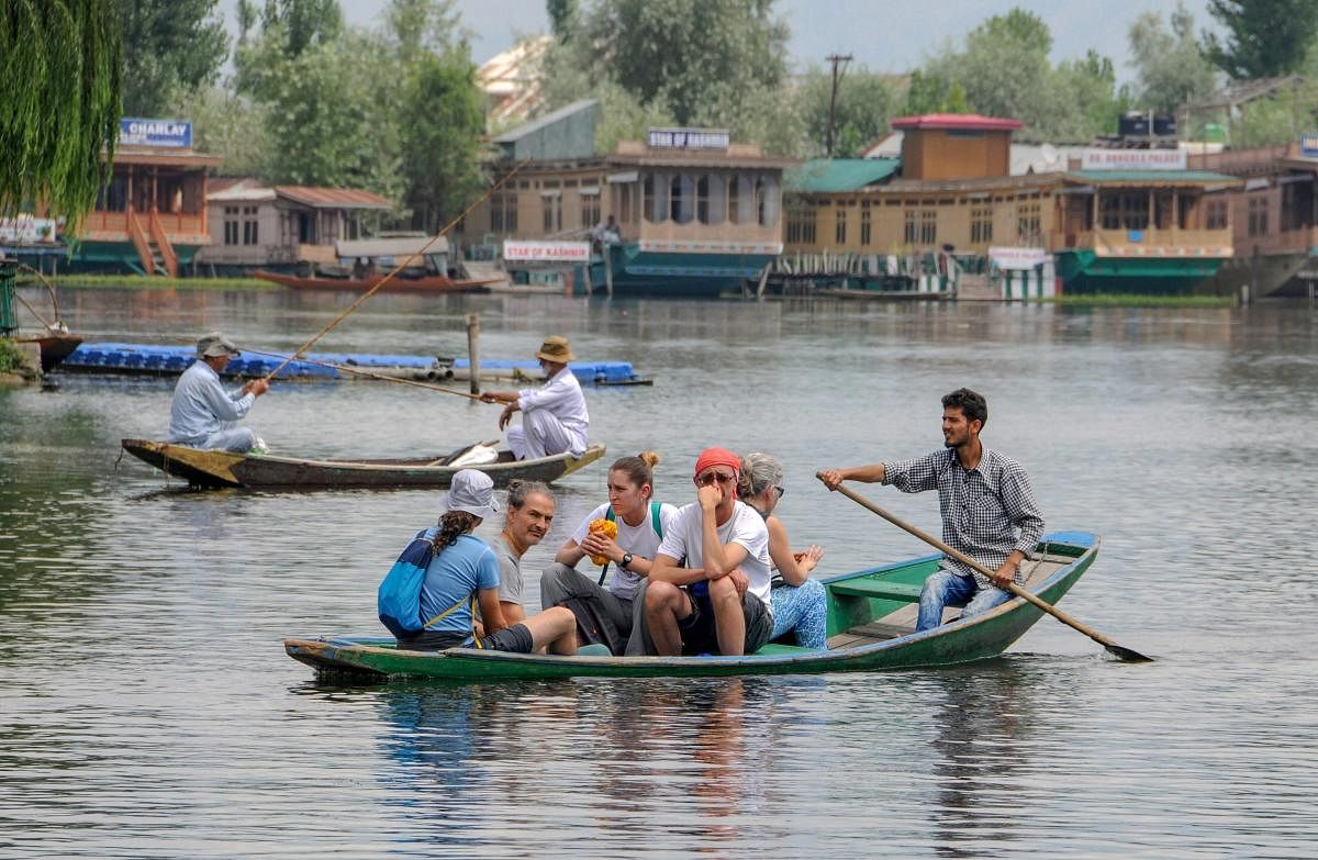 Tourists enjoy a boat ride on the Dal Lake in Srinagar. (PTI Photo)