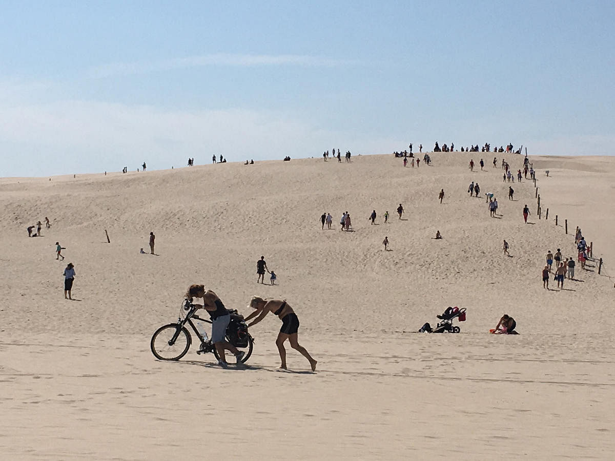 Women push a bike on the sand dunes in Slowinski National Park near Leba, Poland. (Reuters Photo)