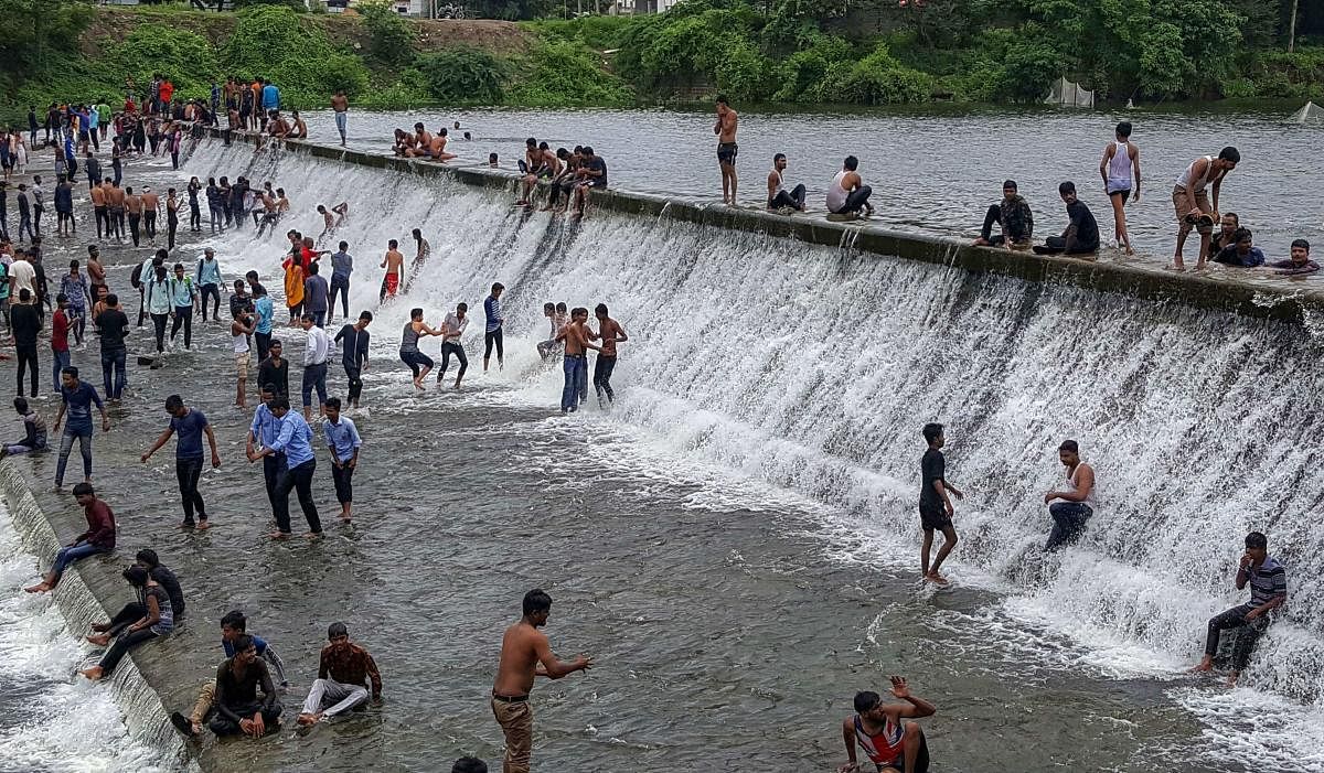 People enjoy at Ambhajhari Lake which is overflowing after rains, in Nagpur, Maharashtra. (PTI Photo)