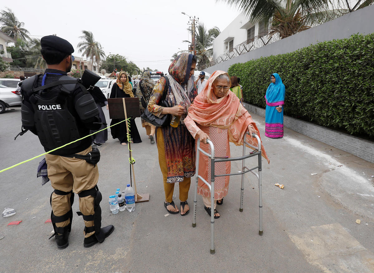A voter on her way to cast her vote during the general election in Karachi, Pakistan. (Reuters Photo)